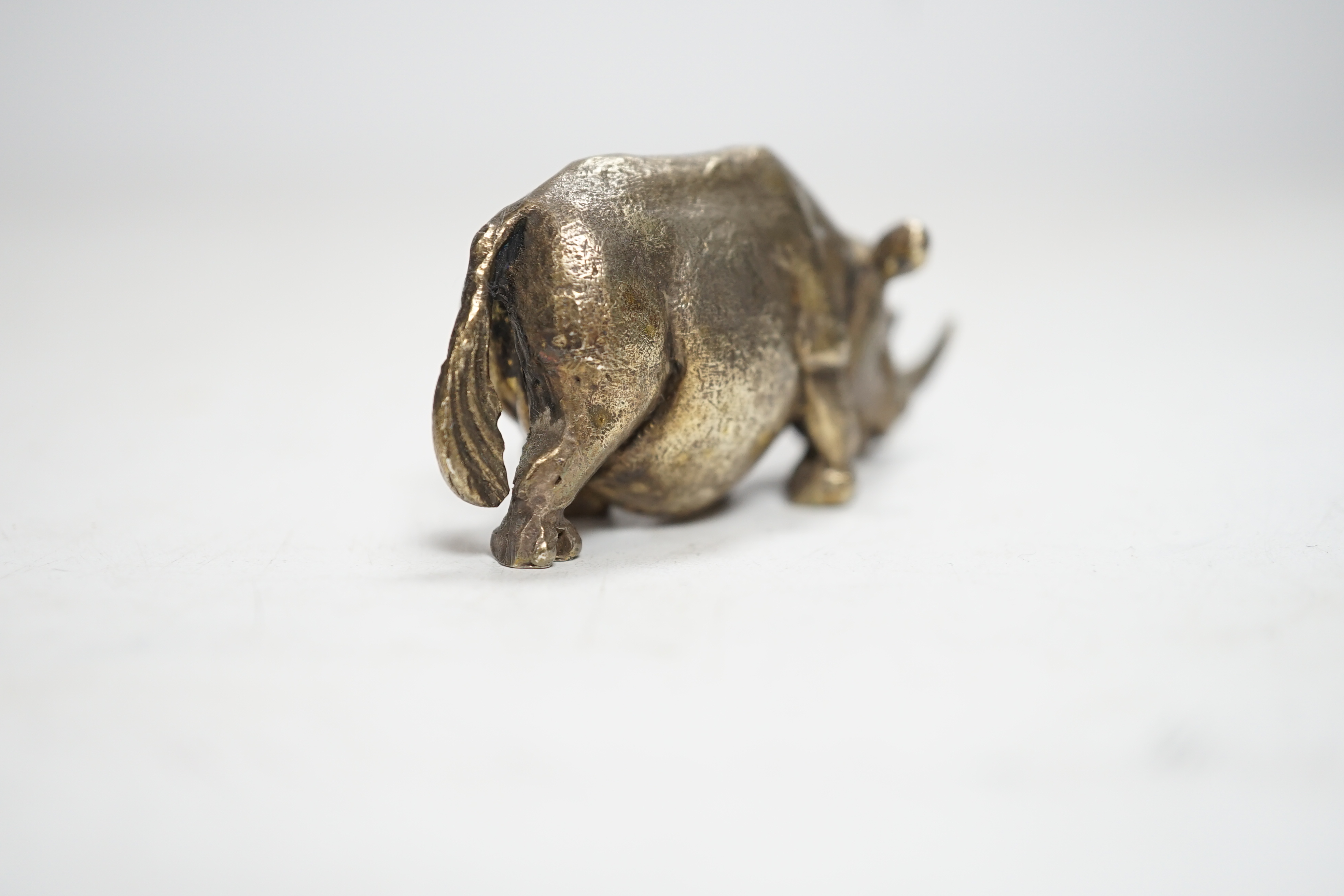 An Elizabeth II silver miniature model of a rhinoceros, by Stuart Devlin, London, 1985, length 55mm.